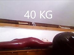 Rubtoy, in latex enjoying a session on the rack
